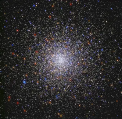 Hubble-Aufnahme des extrem dichten Kugelsternhaufens M80 mit hunderttausenden Sternen in Rot, Orange, Weiß und Blau
